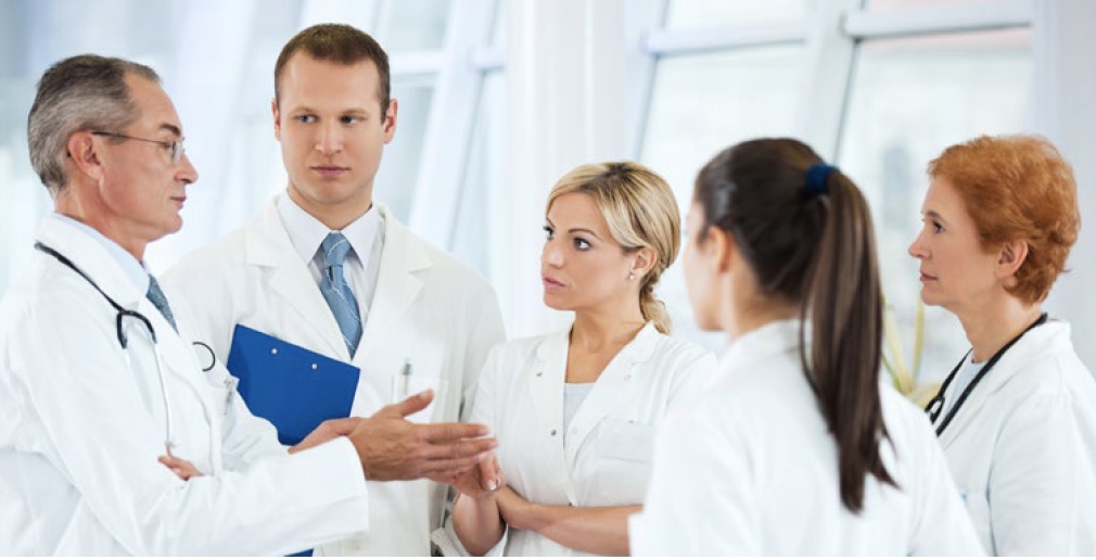Doctors gather in a circle to figure what happened